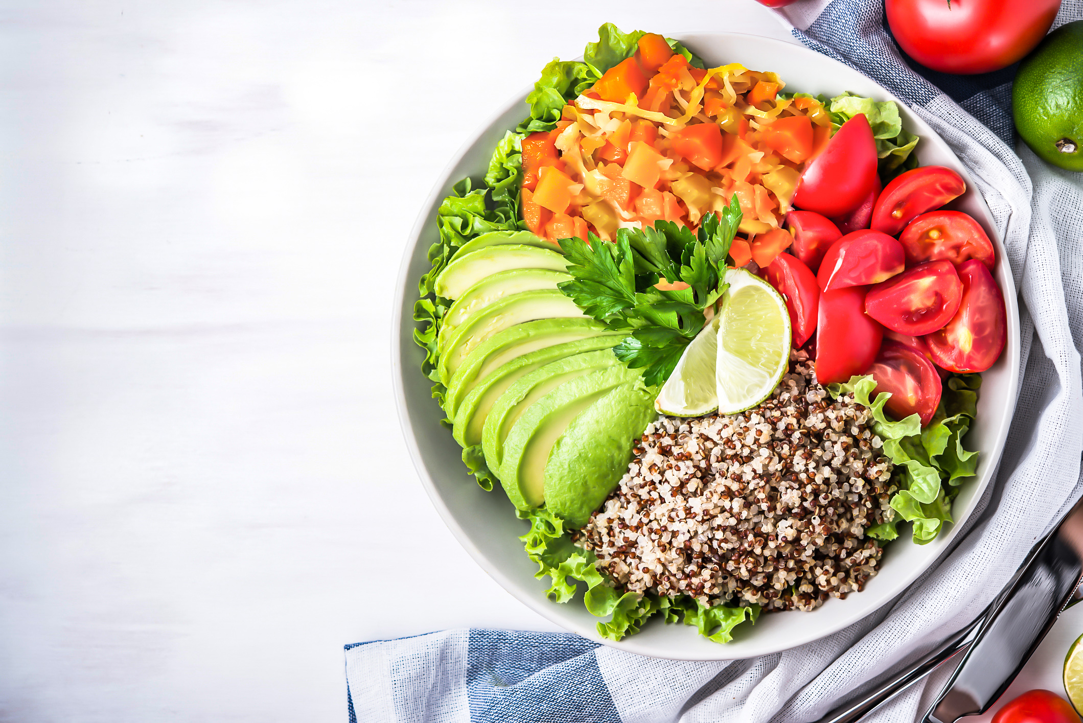 Fresh bowl of greens, avocado, tomato, quinoa, and Spiralz fermented sauerkraut